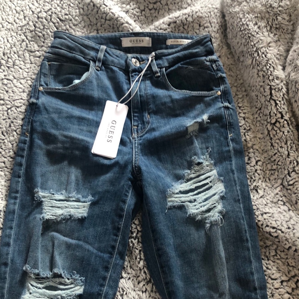 Dark blue distressed Guess jeans in size RG25